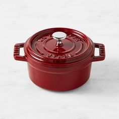 a red casserole on a white table