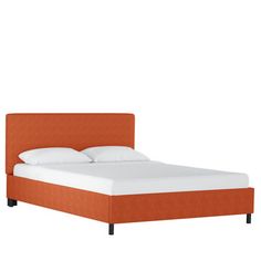 a bed with an orange headboard and white sheets on top of it, against a white background