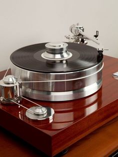 a record player sitting on top of a wooden table