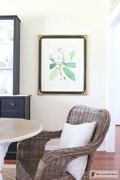 two wicker chairs and a table in a room