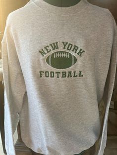 a new york football sweatshirt is displayed on a mannequin