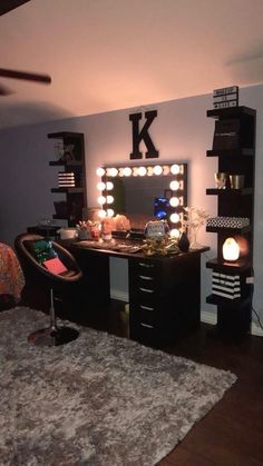 a bedroom with a vanity, mirror and lights