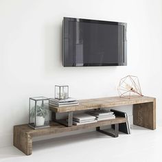 a flat screen tv mounted to the side of a wooden shelf in a living room