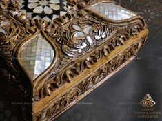 an intricately carved wooden box with glass inserts