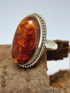 Amber Silver Ring Amber Ring,Orange Cabochon Oval Ring Sterling Silver Ring,Amber Semi Precious Stone Ring,Engagement Ring,Best Seller Amber Ring Why To Wear Silver As a metal, silver has significant health benefits that have been used across cultures for centuries. Silver has a proven track record as a powerful antimicrobial agent fighting infections and aiding in cold and flu prevention, wound healing, and more. Silver also helps with internal heat regulation and circulation. Why To Wear Amber Amber Cabochon Ring For Anniversary, Handmade Orange Rings For Gifts, Formal Orange Oval Rings, Handmade Oval Cabochon Ring For Anniversary, Classic Oval Brown Ring, Classic Brown Oval Ring, Handmade Orange Rings As Gift, Handmade Oval Brown Rings, Adjustable Oval Rings In Brown