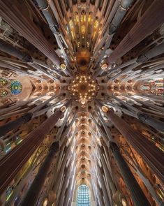 the inside of a large cathedral with many windows and lights on it's ceiling