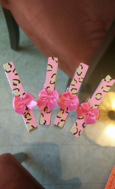 three pink hair clips with bows on them sitting next to a chair in a living room