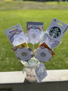 a glass vase filled with cards and flowers