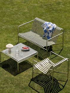 two chairs and a table in the grass