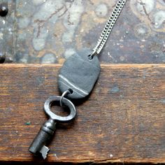 "A steel antique, vintage key, combined with a wishing stone*, hangs from a vintage stainless steel chain. The necklace measures 24\". The pendants average 2 1/4\" to 2 3/4\" long excluding jump rings. The keys have varying degrees of wear on them. I always wonder where they came from. What did they do before becoming a necklace. *A wishing stone is a stone that has a white line going completely around it. Legend has it that if you make a wish for yourself with the rock, it is said to come true, Wishing Stones, Hag Stones, Vintage Key, Heavy Chain, Junk Art, Kraft Gift Boxes, Vintage Keys, White Line, Beach Stones