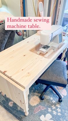 a sewing machine sitting on top of a wooden table next to a blue and white rug