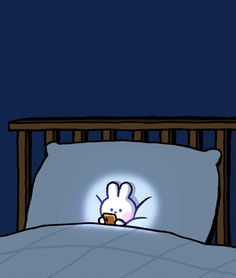 a bed with a cartoon bunny on it's head in the middle of the night