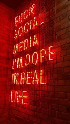 a red neon sign that says social media and i'm dope in real life