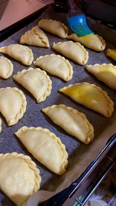 there are many small pastries on the baking sheet