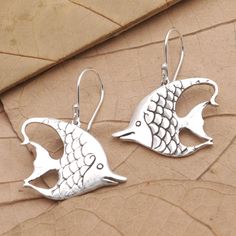 Inspired by the Moorish idol fish Bali's Putu Putri presents this pair of shining silver earrings. Crafted from sterling silver the whimsical earrings are designed with dainty details that emulate fish scales and fins. Silver Fish-shaped Sterling Silver Earrings, Silver Sterling Fish-shaped Earrings, Sterling Silver Fish Hook Earrings, Sterling Silver Fish-shaped Jewelry, Silver Fish-shaped Earrings With Ear Wire, Silver Fish-shaped Earrings With Fish Hooks, Nickel-free Silver Fish-shaped Earrings, Moorish Idol Fish, Moorish Idol