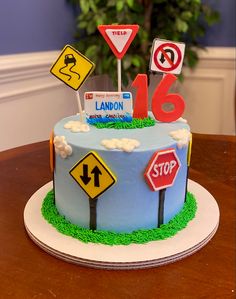 a birthday cake decorated with street signs and traffic signs