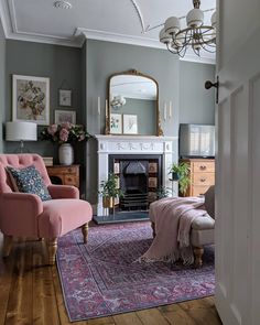 a living room filled with furniture and a fire place next to a mirror on the wall