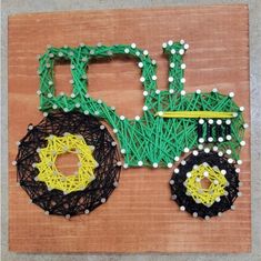 a piece of string art that looks like a tractor