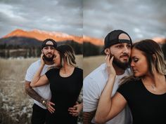 three people are standing in a field with mountains behind them and one person is talking on the phone