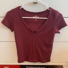 Size: Women's Xs In Amazing Condition! Never Worn Yet! Cute Notch-Neckline Dark Red Waffle Material Shirt From Hollister, Super Cute. -All Products Are From A Smoke Free Home! -Feel Free To Ask Questions! -Reasonable Offers Welcomed! -Fast Shipping! -Orders $40 And Above Are 15% Off! Red Ribbed V-neck Top, Dark Red Crop Top, Hollister Clothes, Simple Clothes, Hollister Crop Tops, Baby Graphic Tees, Red Crop Top, Shipping Orders, Hollister Tops