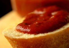 a hot dog bun with ketchup on it