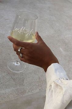 a person holding a wine glass in their hand