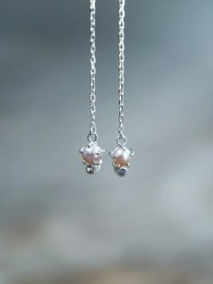 These dainty earrings feature a prong-set pearl and spinel embedded below it at the end of the threaders. The pearl's soft gleam is complemented by the spinel's subtle sparkle, creating an elegant and timeless design. Pearl is a birthstone for June. Spinel is the August birthstone and one hell of a powerful elixir. A versatile pair of pearl threader earrings, wear them for a night out or an everyday look. Graceful Silver Pearl Earrings As Gift, Graceful Silver Pearl Earrings For Gift, Delicate Sterling Silver Pearl Earrings For Everyday, Dainty Sterling Silver Pearl Earrings For Anniversary, Dainty Silver Earrings With Pearl Charm, Silver Everyday Pearl Pendant Earrings, Sterling Silver Fine Jewelry Pearl Earrings, Delicate White Gold Pearl Earrings In Sterling Silver, Silver Dainty Pearl Earrings With Pearl Charm