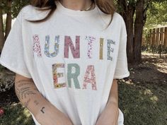 a woman wearing a white shirt with the words don't be afraid written on it