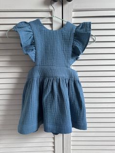 "Dress made of muslin cotton fabric with ruffled braces. The dress has an elasticated waist for a perfect fit.  Avalible sizes (child height ):  1 year (approx. height 31\"/80cm)  2 years (approx. height 34\"/86cm)  3 years (approx. height 37\"/92cm)  4 years (approx. height 40\"/104cm)  5 years (approx. height 43\"/110cm) The item is made to order and it takes about 3-7 days to go and will be shipped immediately when it will be ready. I will inform you by e-mail, when your package has been sent. If you have any questions, please contact me. Like us on Facebook for more photos https://www.facebook.com/pages/Lilly-Rose/406459142796041 THANK YOU FOR VISITING LILLY ROSE" Cotton Dress With Smocked Back And Ruffled Straps, Cotton Ruffle Dress With Flutter Sleeves For Summer, Summer Cotton Ruffle Dress With Flutter Sleeves, Cotton Ruffle Sundress For Playdate, Cotton Ruffled Sundress For Playdate, Cotton Sundress With Ruffles For Playdate, Cute Cotton Suspender Dress For Summer, Summer Cotton Sundress With Ruffles, Cotton Ruffle Dress With Ruffled Straps