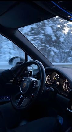 the interior of a car driving on a snowy road