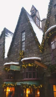 an old building with christmas lights on it