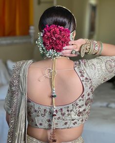 a woman in a sari with flowers on her back