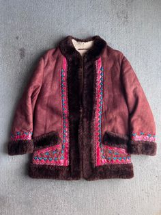 Beautiful 1960s / 1970s Embroidered shearling coat. Good vintage condition. Clasps in the front for closure.  21" Pit to pit  30" Length  18" Shoulder  21" Outer Sleeve All sales final. please ask any questions you have before buying - Thanks! 1960s Jacket, Vintage Embroidered Winter Outerwear, Retro Embroidered Winter Outerwear, Vintage Brown Embroidered Outerwear, Fall Winter Jacket, Penny Lane, Shearling Coat, Hippie Bohemian, Winter Coats Women