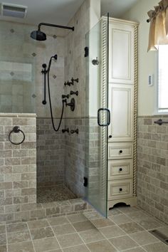 a walk in shower sitting inside of a bathroom