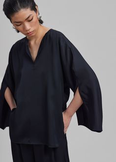 Color: Black Lightweight fluid fabric Relaxed fit V neckline Split dolman sleeves Slip on style Unlined 100% Acetate Machine Wash Cold By Malene Birger. Imported Denim Suit, Loose Fit Blouse, Paris Woman, Malene Birger, By Malene Birger, V Neckline, Swimwear Accessories, Dolman Sleeve, Black Blouse