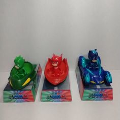 three plastic toys sitting on top of each other