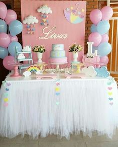 a table topped with lots of cake and balloons