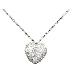 Unveil your inner romantic with the Cartier Diamond 18k White Gold Heart Shaped Pendant Necklace, a symbol of love and elegance that captures the essence of Cartier's timeless craftsmanship. This exquisite pendant necklace pairs the radiance of diamonds with the sophistication of 18-karat white gold in a heart-shaped design that's as enduring as it is captivating. This pendant necklace is crafted with the utmost precision from 18-karat white gold, a metal known for its brilliant luster and versatility. The pristine white gold setting serves as the perfect canvas for the sparkling diamonds. The pendant takes the form of a classic heart shape, an enduring symbol of love and affection. Cartier's interpretation of this iconic motif is both elegant and timeless, making it a cherished piece for Heart Shaped Diamond Necklace, Heart Necklace Tiffany, Cartier Diamond, Interlocking Circle Necklace, Heart Shaped Pendant Necklace, Heart Shaped Pendant, Heart Necklace Diamond, Heart Shaped Necklace, Infinity Necklace