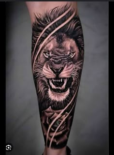 a man's leg with a tattoo of a lion on it and some wires