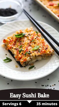 a white plate topped with food next to chopsticks