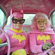 two people dressed in pink and yellow sitting in the back of a car with their faces painted like batgirls