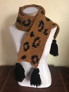 Handmade crochet leopard scarf. Approximately 32 inches long and 5 inches wide, without tassels and laying flat. Tassels add another 5.5 inches. Made with easy care acrylic yarn. Crochet Leopard Print, Leopard Crochet, Crochet Leopard, Scarf With Tassels, Leopard Scarf, Leopard Print Scarf, Acrylic Yarn, Handmade Crochet, Scarf Wrap