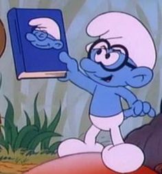 the smurf is holding an open book in his hand and pointing at it