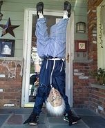 a man standing on his back in front of a door with one leg raised up