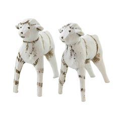 two white ceramic sheep standing next to each other