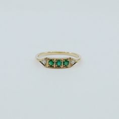 This is Ms. Goodbar, a little like a Mr. Goodbar candy bar in that it's delicious! Amazing green colored goodness in the middle sandwiched between two diamonds. The details in this ring are not to be missed, truly unique and special. Details: 14k (available in rose, white or yellow) Outer diamonds measure about 1.6mm Emeralds measuring about 2mm each Free Shipping on Domestic Orders Materials: emerald, diamond, 14k gold Need your ring bigger than whats offered? An additional fee will be applied Emerald Pinky Ring, Mr Goodbar, Antique Emerald Ring, Rose Gold Cuff Bracelet, Emerald Ring Vintage, Dainty Band, Future Engagement Rings, Initial Earrings, Green Rings