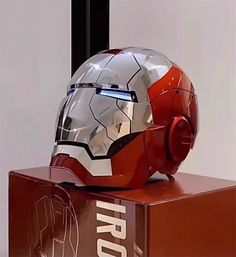 an iron man helmet sitting on top of a box