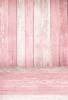 an old pink wooden bench against a white painted wall with vertical planks in the background