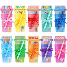 there are many different colored pencils in the box with ribbons on them and tied together