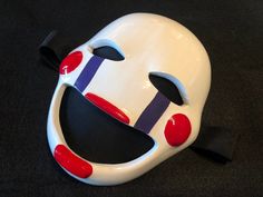 Are you looking for the perfect accessory to give your cosplay or Halloween costume that final touch? Look no further! 🎃 ✨ Our exclusive Puppet Mask is not just a showstopper, but also meticulously handcrafted with attention to detail. ��🌟 The fine lines and unique design make it a distinctive masterpiece that you can wear with pride. 🎨 🤩 Why our Marionette Mask? 🎪 🎭 Unique Design: This mask is not just any marionette mask. It's a statement! Every detail has been thoughtfully designed and ha Masked Cosplay Ideas, Marionette Cosplay, Weird Masks, Fnaf Mask, Fnaf Marionette, Cosplay Masks, Fnaf Costume, The Mask Costume, Fnaf Cosplay